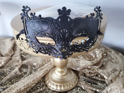 A black masquerade mask on gold elements